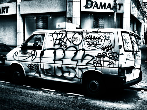 A VW Transporter covered with graffiti in Paris.